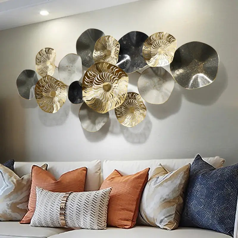 Close-up of gold wall decor accent highlighting its intricate texture against a neutral wall.