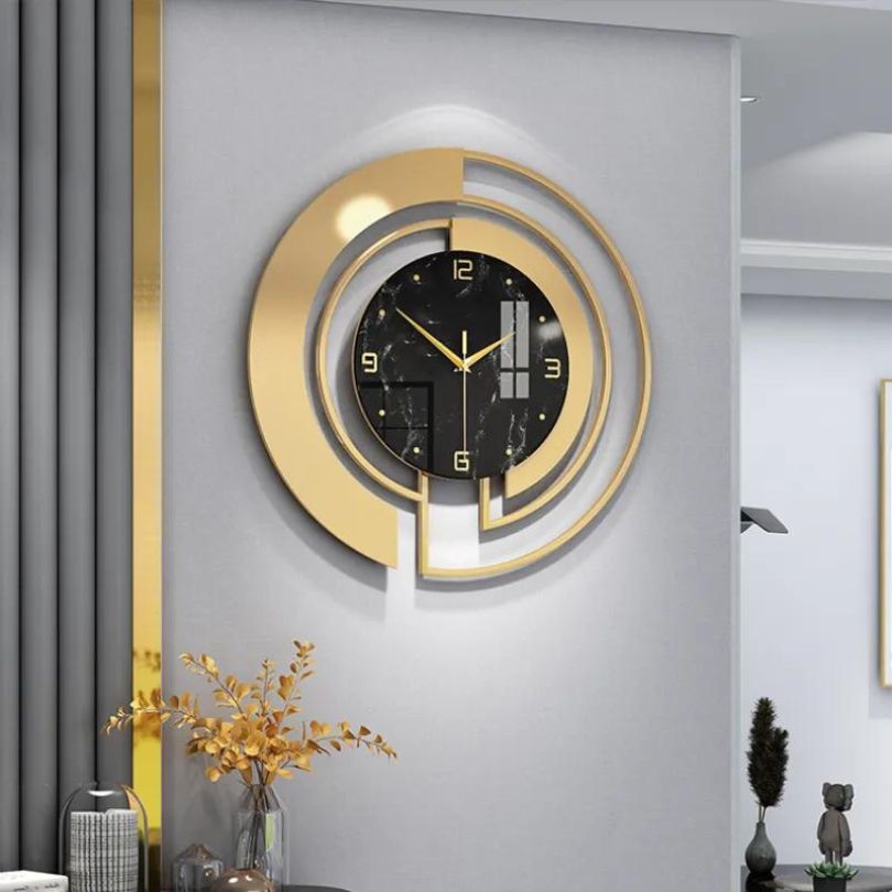 Close-up of the gold and white details of the decorative wall clock, emphasizing its luxury finish.
