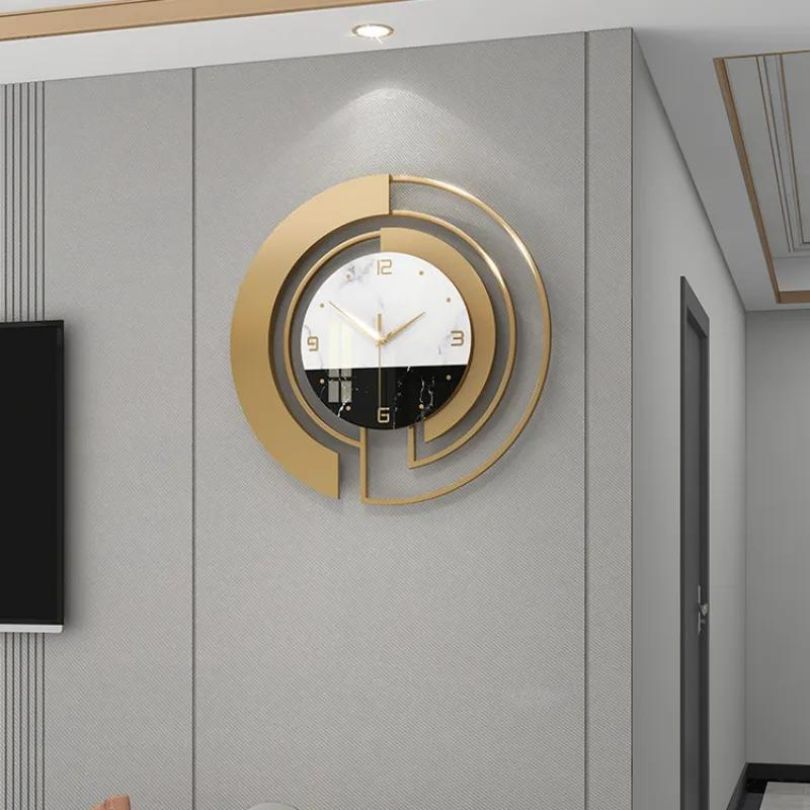 Close-up of the gold and white details of the decorative wall clock, emphasizing its luxury finish.
