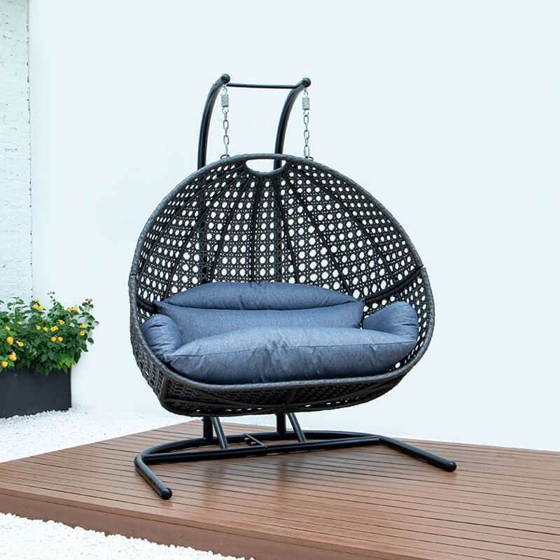 Premium two-seater wicker hanging egg chair in a serene garden setting