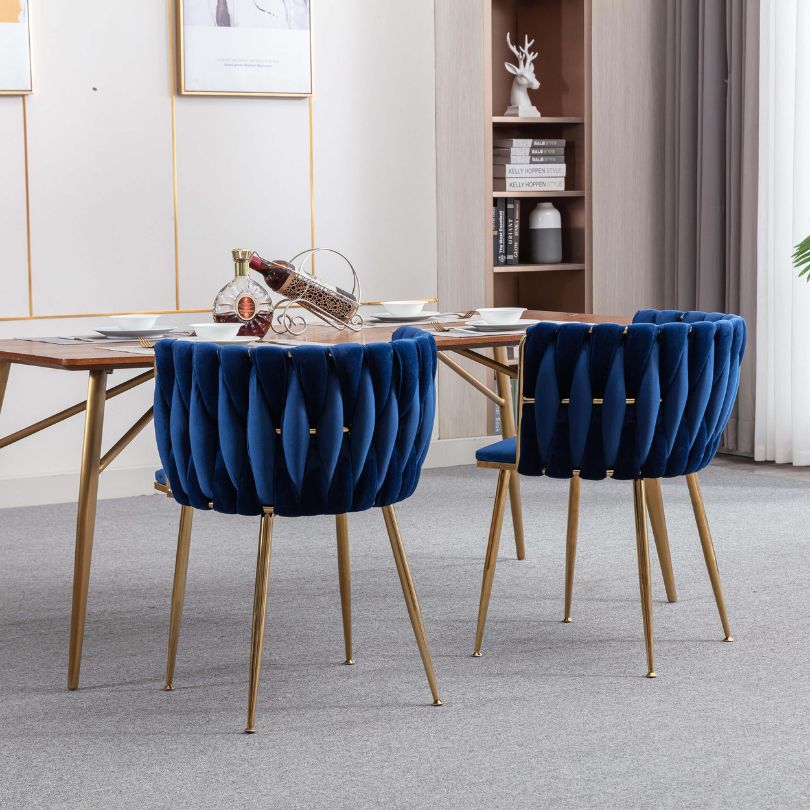 Elegant blue velvet dining chair featuring gold legs from the side view, perfect for dining rooms.