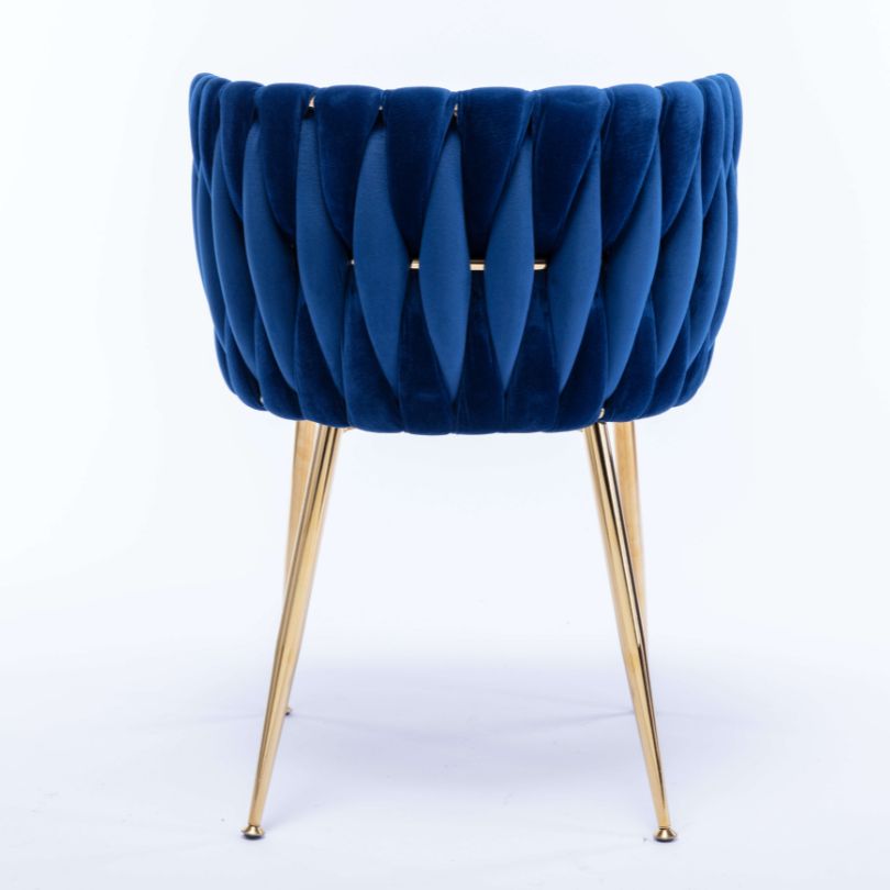 Stylish blue velvet dining chair positioned at a beautifully set dining table.