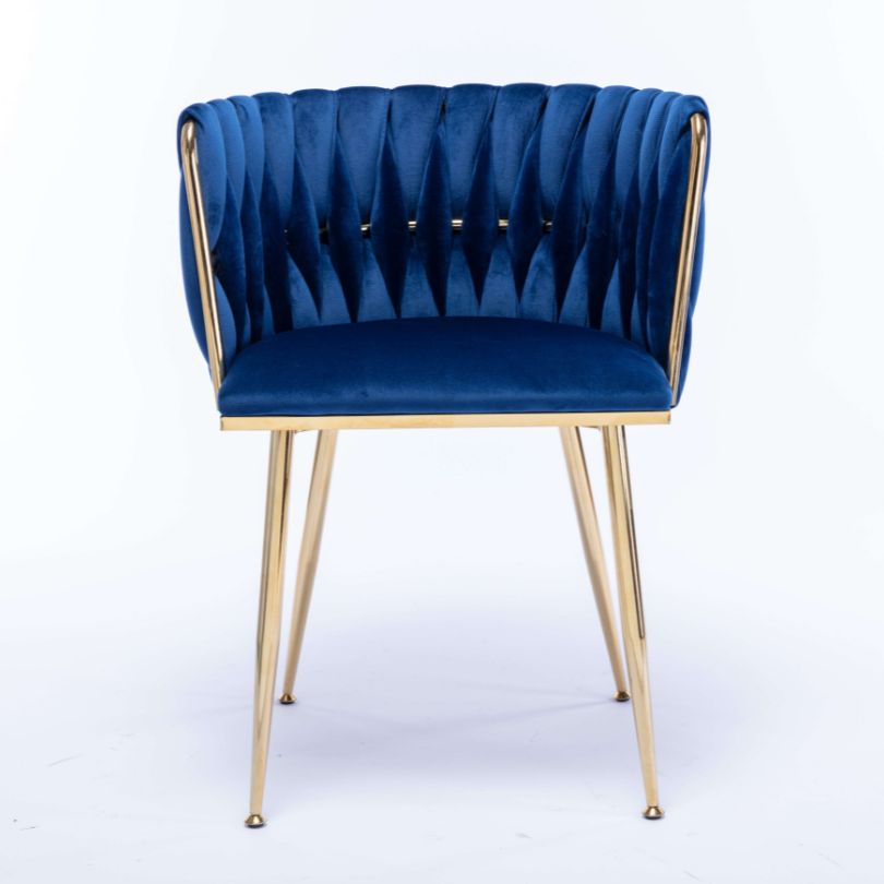 Stylish blue velvet dining chair positioned at a beautifully set dining table.
