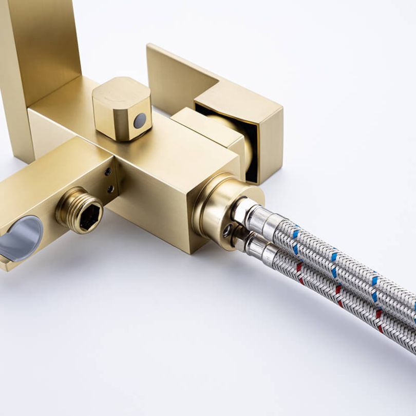 Close-up of the elegant gold freestanding bathtub mixer faucet with hand shower.