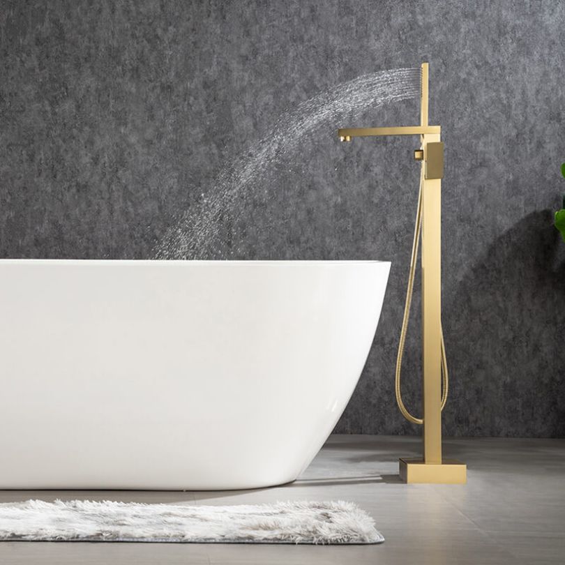 Luxurious brushed gold bathtub faucet installed in a stylish modern bathroom.