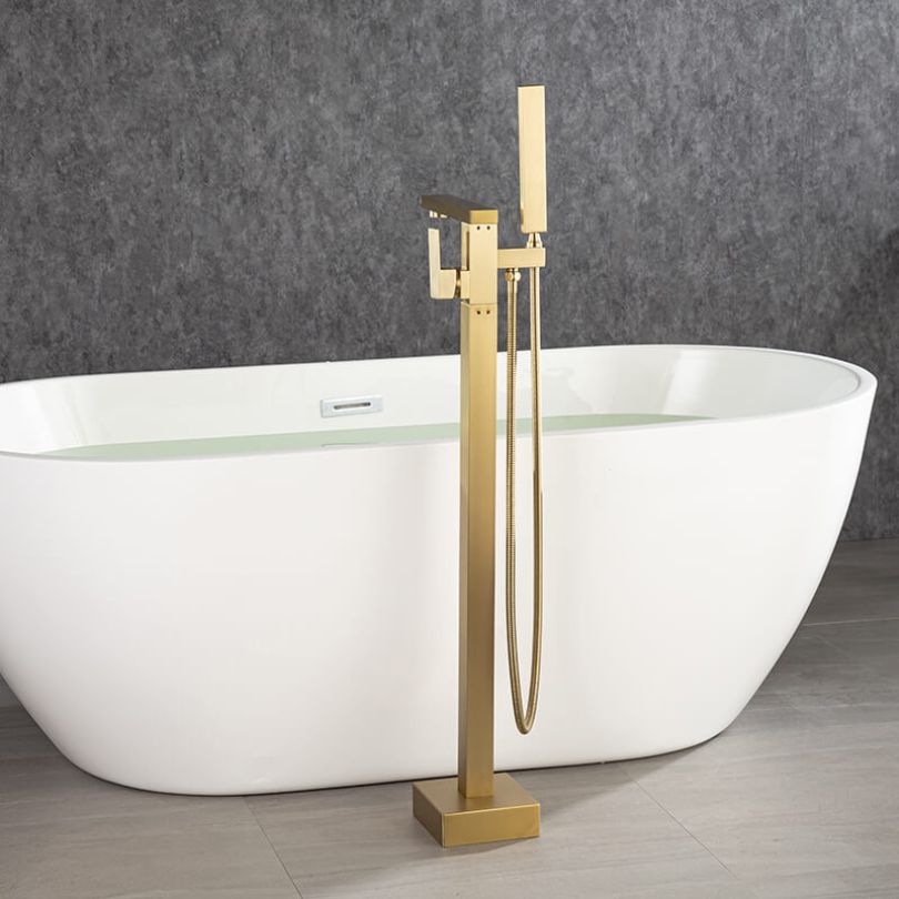 Close-up of the elegant gold freestanding bathtub mixer faucet with hand shower.