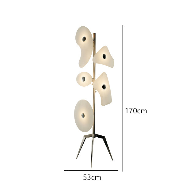The Elegant Orbital Floor Lamp illuminating a cozy reading nook with its soothing light.