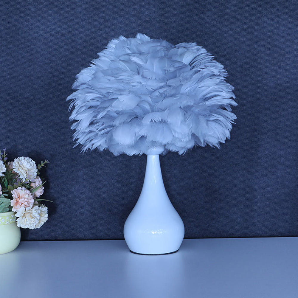 Elegant feather lamp showcasing soft pink feathers, ideal for modern decor.