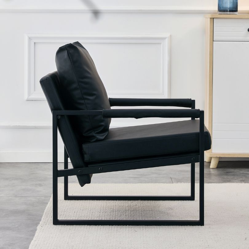 Elegant mid-century accent chair in a cozy reading nook with books and a soft throw blanket.