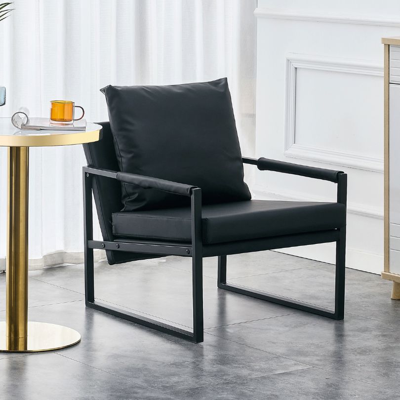 Stylish black PU leather chair placed in a modern living room setting, highlighting its design.