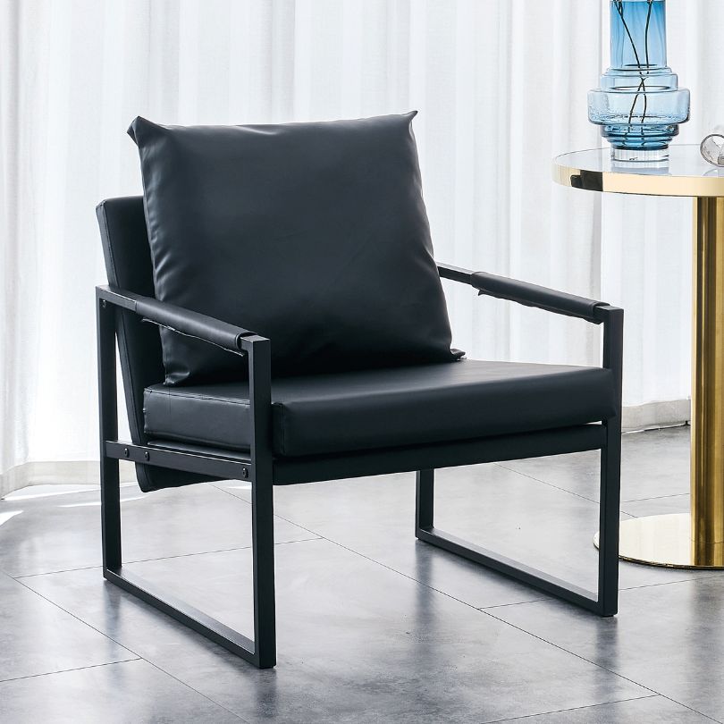 Stylish black PU leather chair placed in a modern living room setting, highlighting its design.
