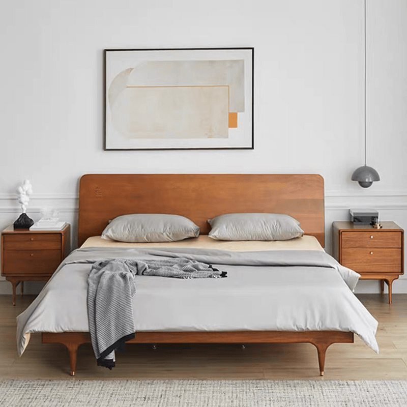 Angled view of mid-century modern nightstand in walnut finish with raised legs and two drawers