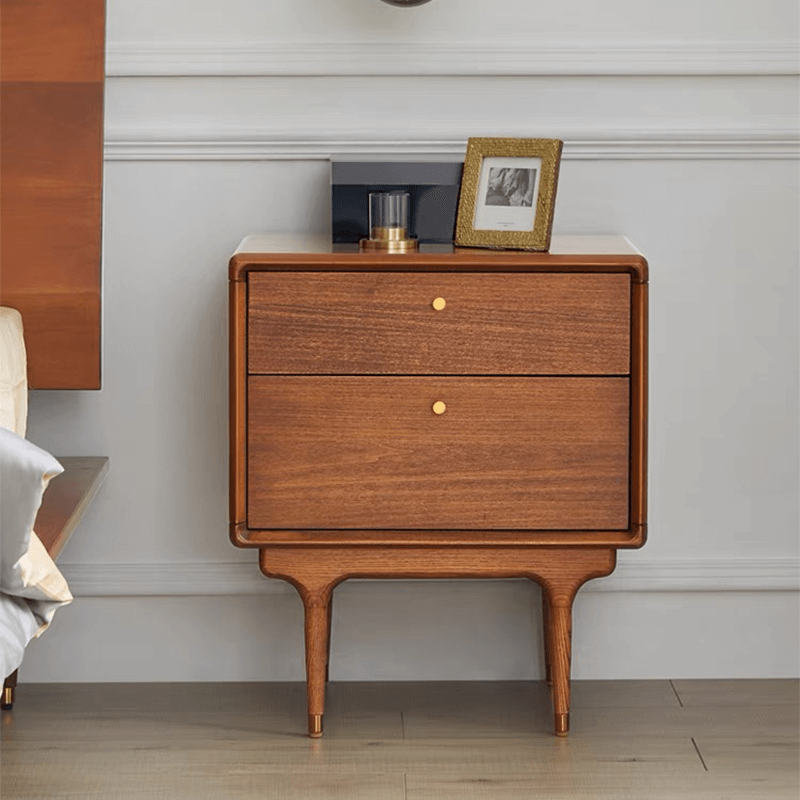 Angled view of mid-century modern nightstand in walnut finish with raised legs and two drawers