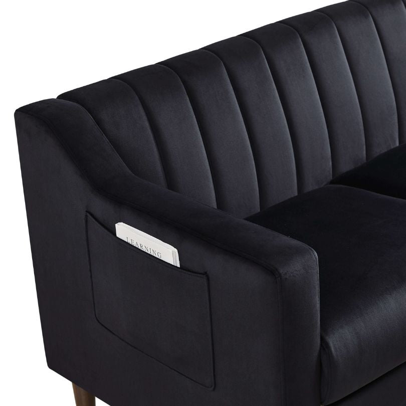 Front view of stylish black tufted barrel accent chair with wooden legs.