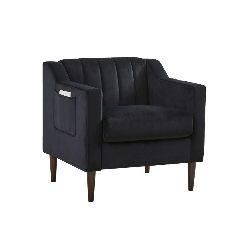 Close-up of the velvet material on the tufted accent chair with wooden legs.