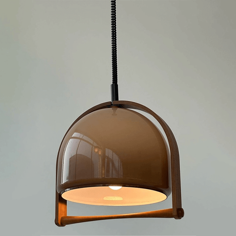 Timeless Mid-Century Dome Pendant Lamp showcasing adjustable suspension wire and warm lighting in a cozy living room setting.