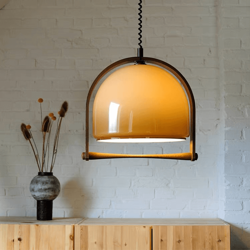 Timeless Mid-Century Dome Pendant Lamp showcasing adjustable suspension wire and warm lighting in a cozy living room setting.