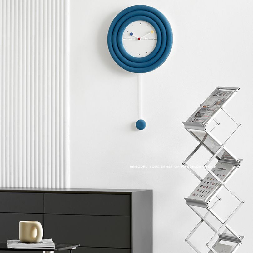 Close-up view of the bamboo material and metallic accents of the minimalist clock on a white wall.