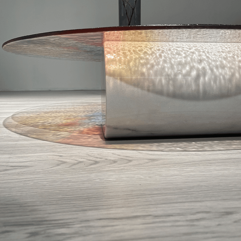 Vibrant Ripple Glass Coffee Table showcasing its unique water rippling effect in a modern living room setting.