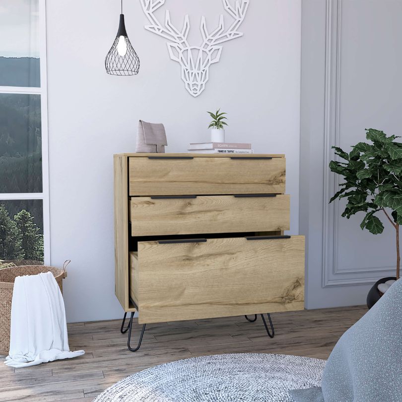Light oak wooden chest drawer showcasing its sleek design and functionality in a modern bedroom setting.
