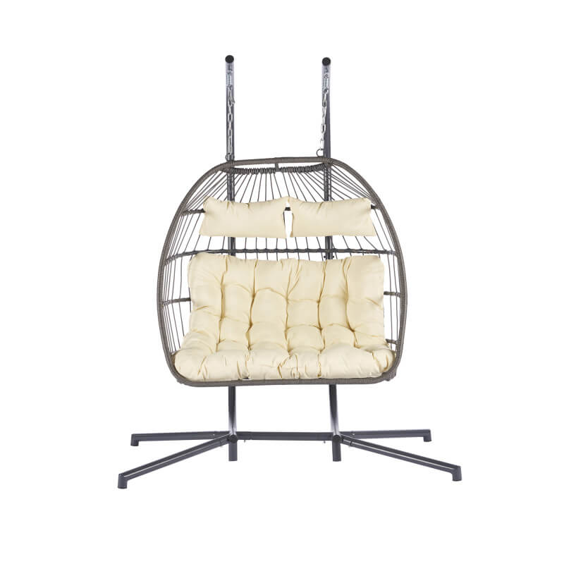 Rattan egg chair hanging elegantly in a garden setting.