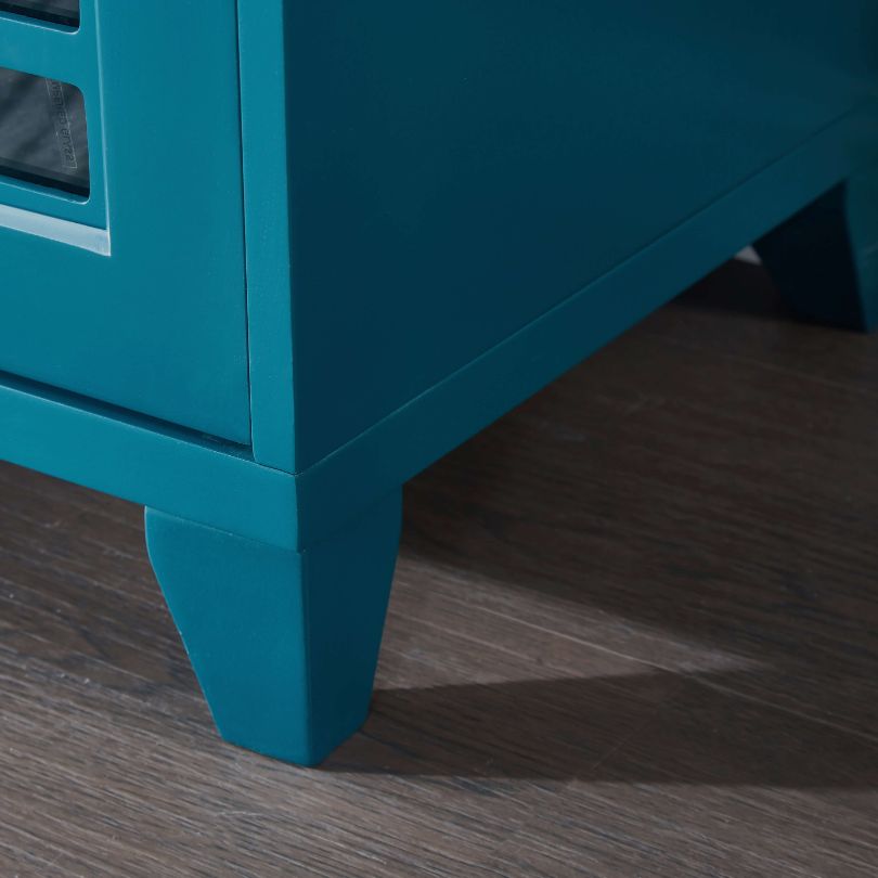 Dining setup featuring stylish glass door cabinet for dining area with teal accents.
