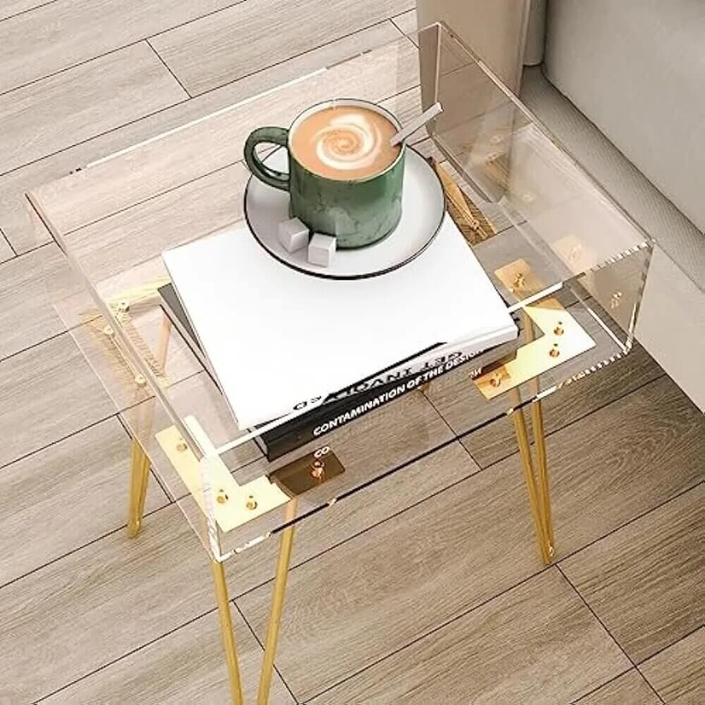 Modern acrylic nightstand styled with a lamp and books on top.