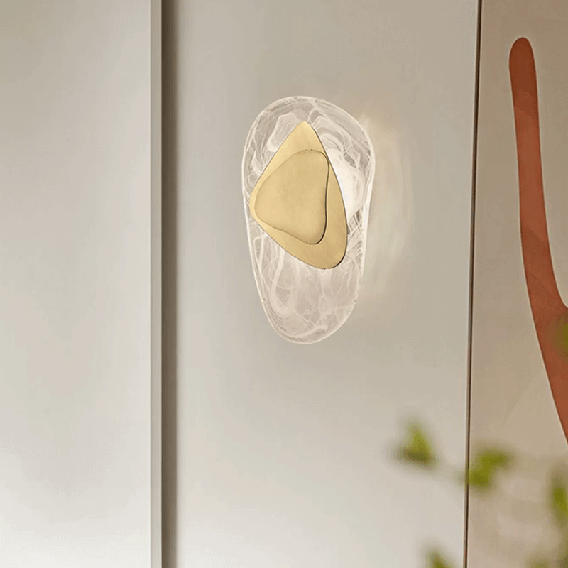 The wall lamp installed in a cozy corner, demonstrating its own light source and decorative appeal.