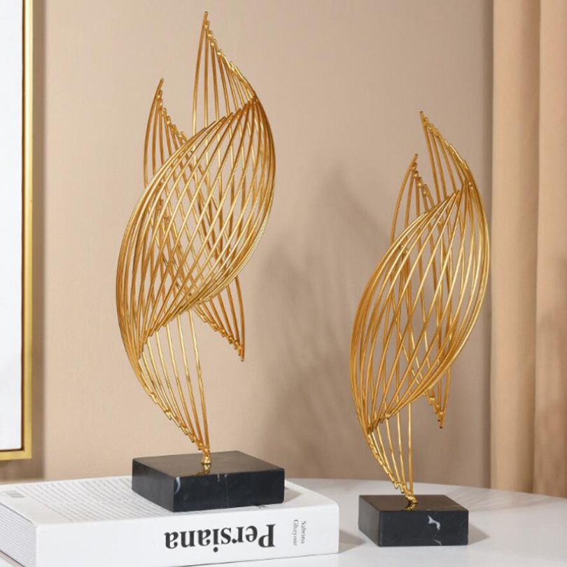 Wavy metal ornament on an office desk, enhancing the workspace ambiance.