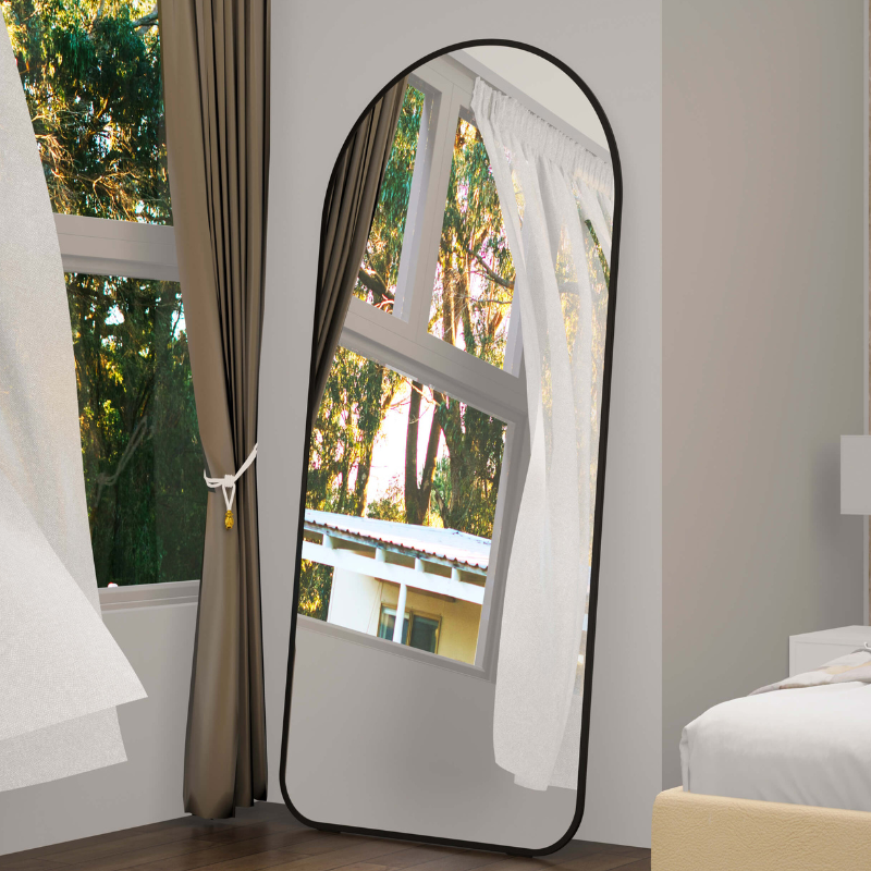 Elegant arch full-length floor mirror against a light wall, showcasing its sleek design.