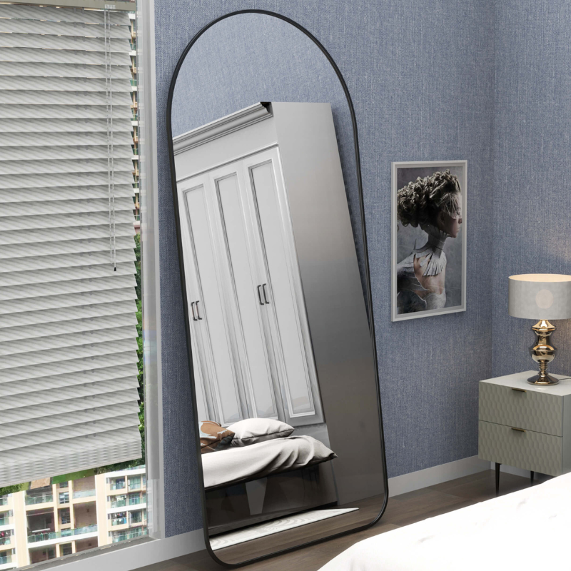 Elegant arch full-length floor mirror against a light wall, showcasing its sleek design.