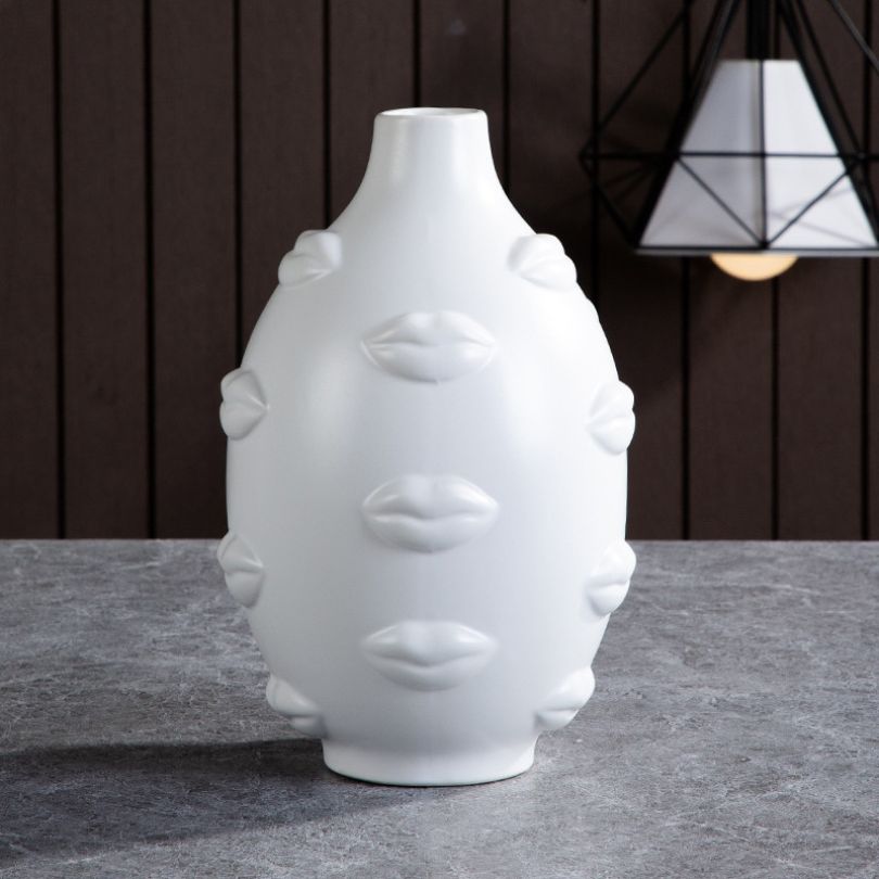 Chic 3D lip print plant pot showcasing modern art style in a bright living room setting.