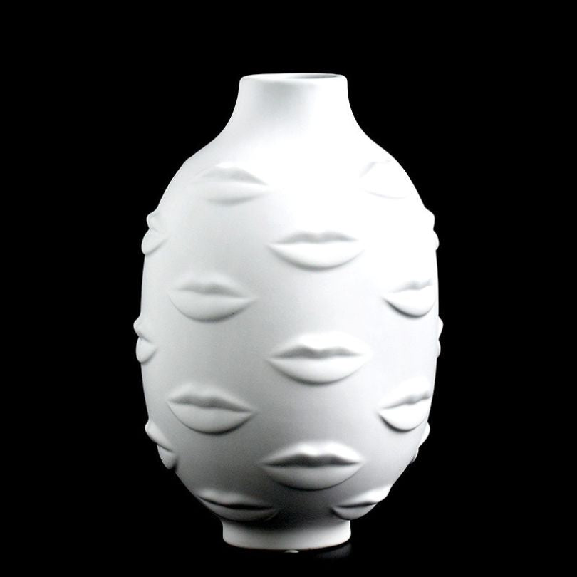Stylish 3D lip print vase displayed with lush plants, ideal for adding a contemporary touch to any bedroom.