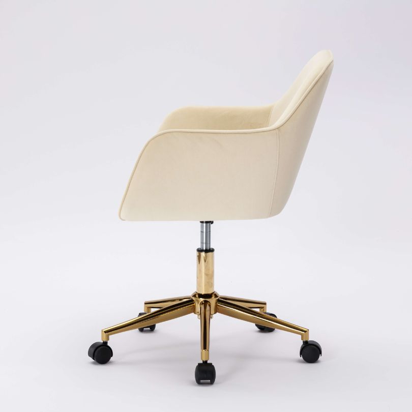 Elegant beige velvet swivel chair showcasing its plush upholstery and swivel feature.