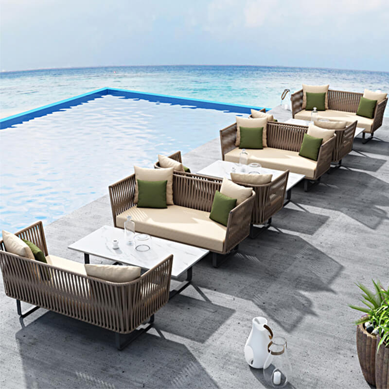 Close-up of the coffee table and footstool from the Elegant Rattan Modular Outdoor Sofa Set, highlighting the craftsmanship.