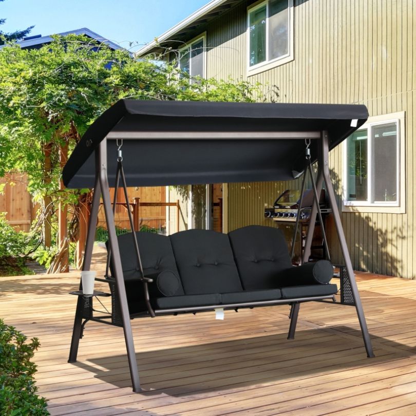 Stylish black canopy swing chair in a garden setting, perfect for outdoor seating.