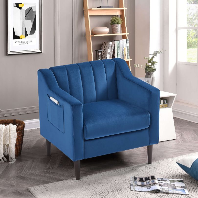 Side view of chic blue velvet tufted barrel accent chair showcasing its elegant design and wooden legs.