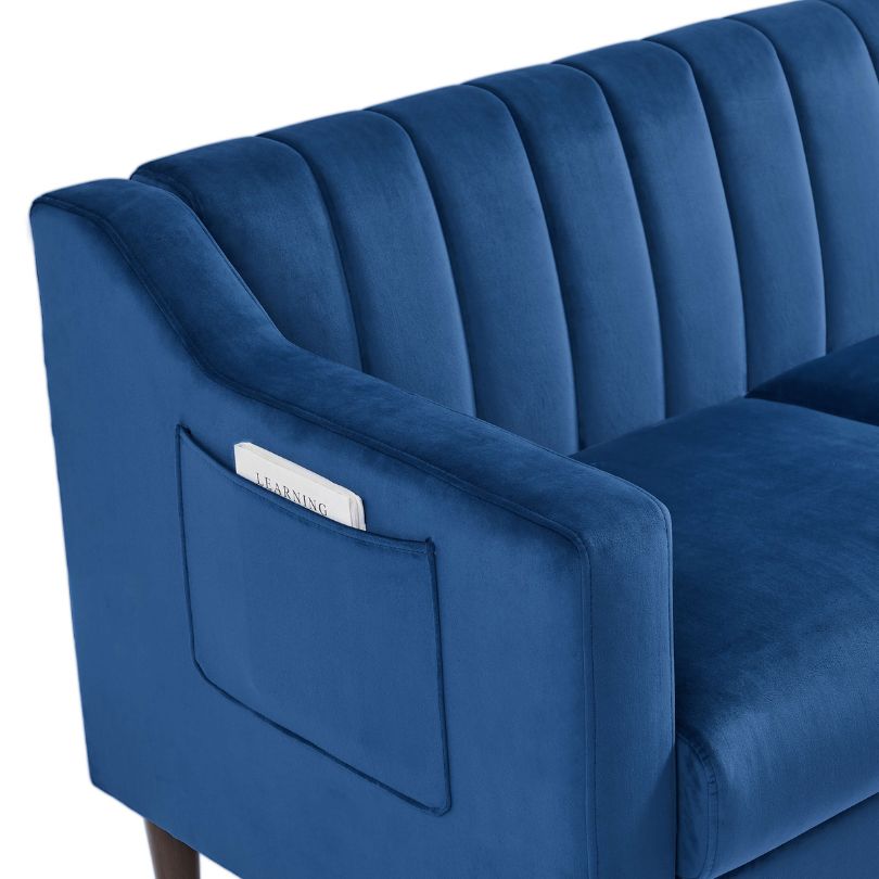 Side view of chic blue velvet tufted barrel accent chair showcasing its elegant design and wooden legs.