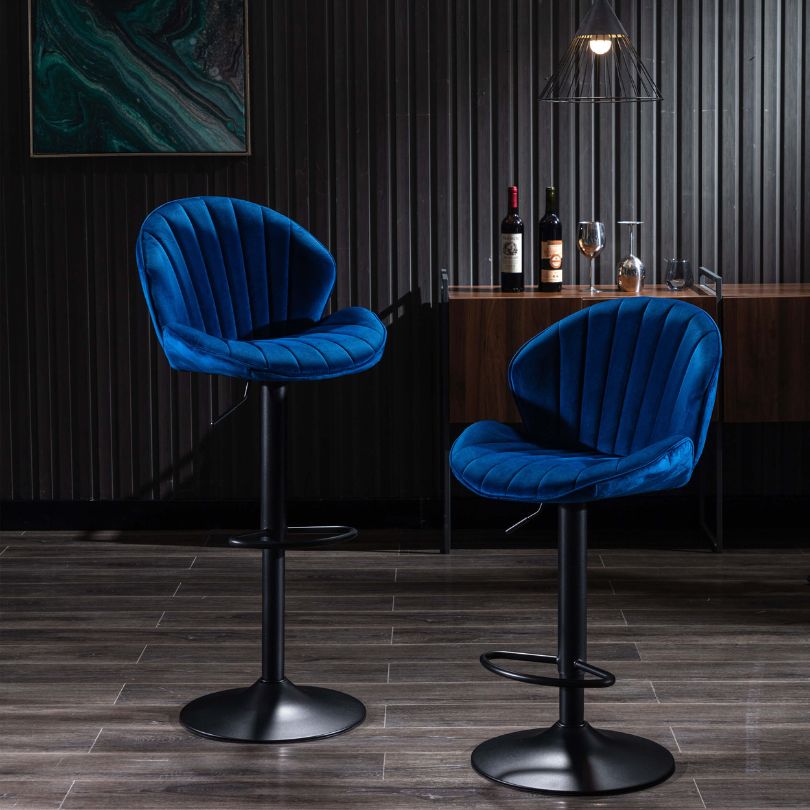Adjustable blue velvet bar stools in modern kitchen setting