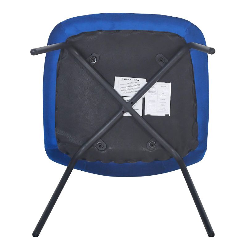 Side perspective of a blue velvet dining chair set in a stylish dining room, highlighting its elegant color.