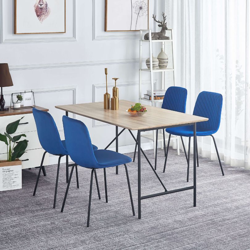 Front view of luxurious blue velvet dining chair showcasing its modern design and plush seating.
