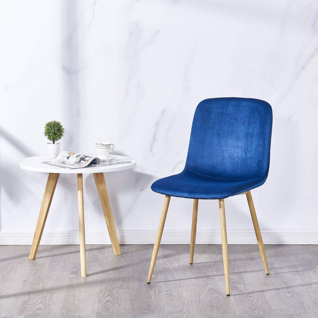 Elegant blue velvet dining chair from the side, highlighting its modern design and plush upholstery.