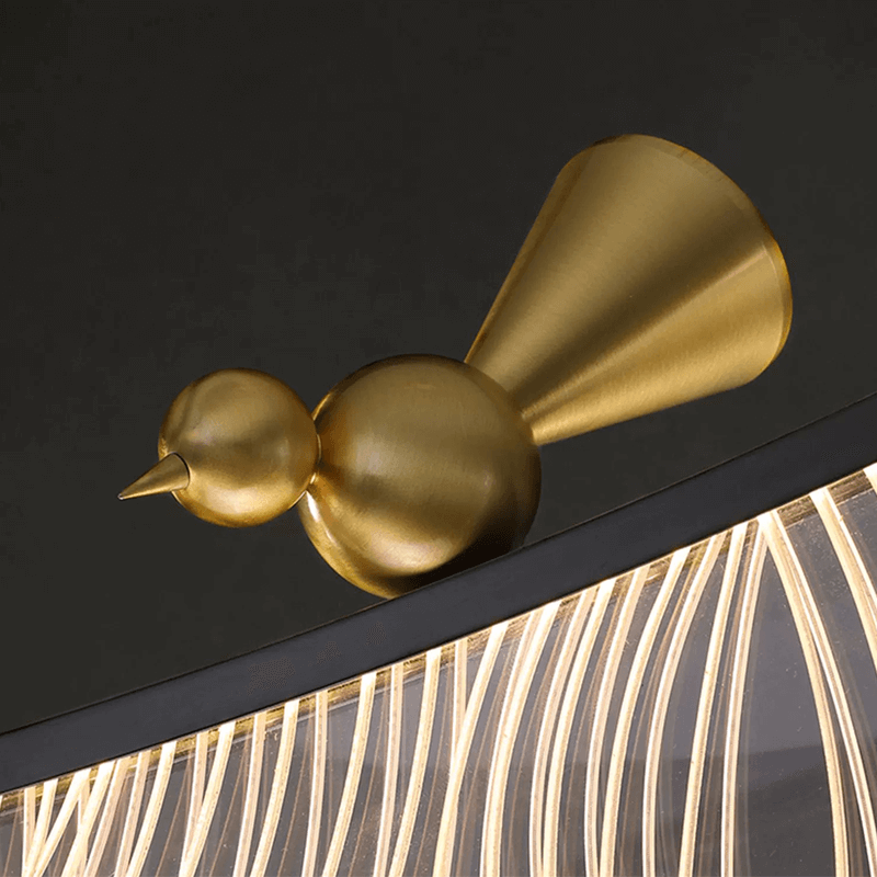 Triple bronze feather chandelier illuminating a cozy dining area.