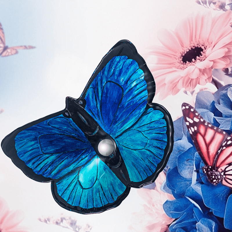 Vibrant blue butterfly bathroom sink displayed elegantly with the included waterfall faucet.