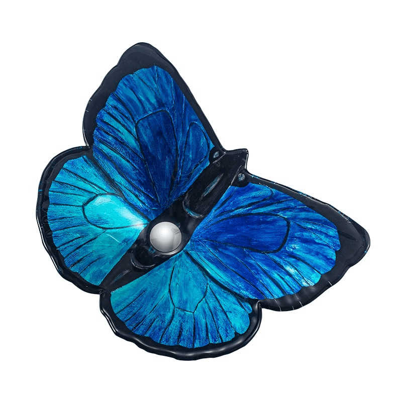 Vibrant blue butterfly bathroom sink displayed elegantly with the included waterfall faucet.