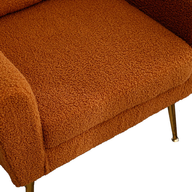 Cozy caramel boucle chair featuring a throw pillow, perfect for relaxation.