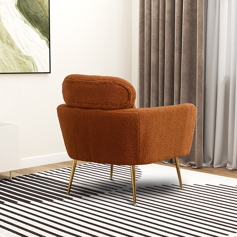 Cozy caramel boucle chair featuring a throw pillow, perfect for relaxation.