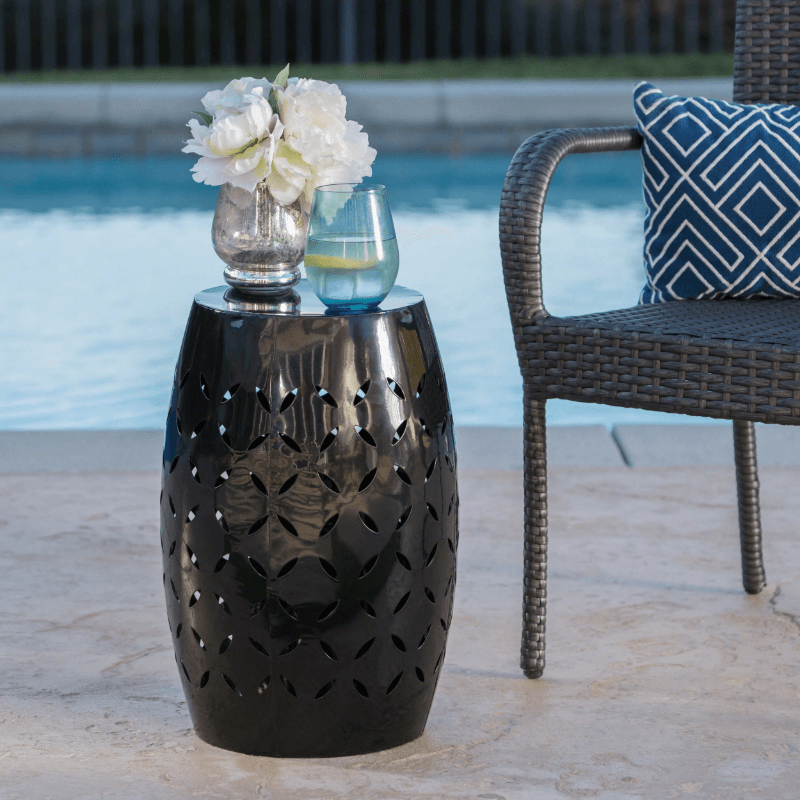 Cataleya modern iron side table in a stylish outdoor setting