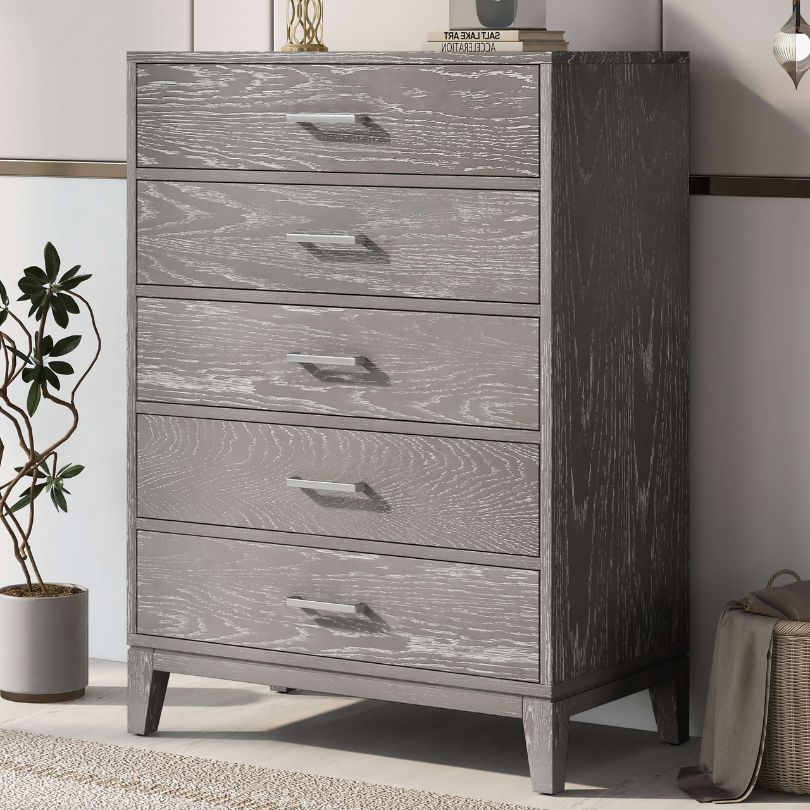 Close-up of grey wooden dresser showing textured finish and modern drawer handles