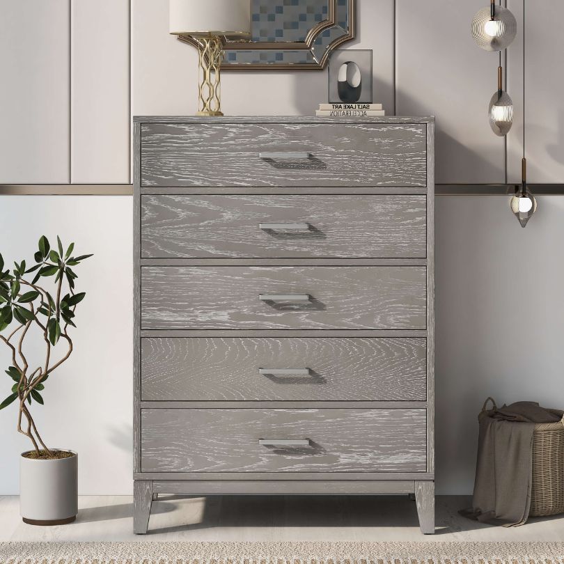 Close-up of grey wooden dresser showing textured finish and modern drawer handles